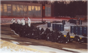 Hazardous materials workers outside dormitory at the State University of New York at New Paltz, January 1992. See photo tour for more info.